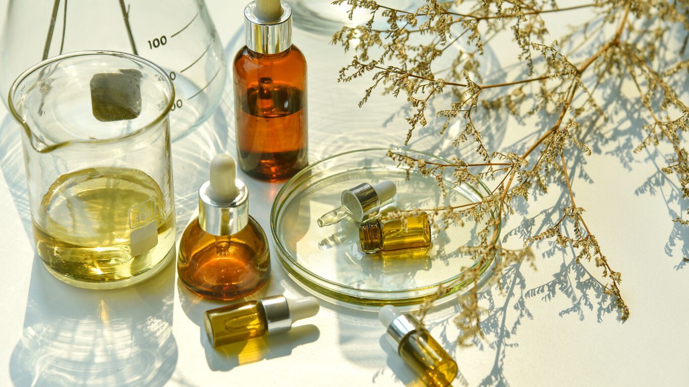 Beauty Beauty Website in Light Pink Red Clean Neutrals Style (Website) (8) A table with some bottles of oils and a bowl