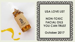 A bottle of facial oil sitting next to a package.